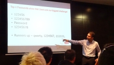 A representative from RSA points to a screen filled with common passwords people use