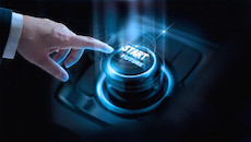 A button representing the future is being pushed by a man in a suit