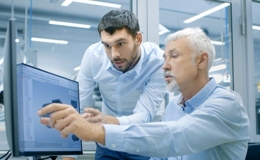 Create a custom application. Two men discuss the creation of software