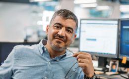 Building high performance IT Teams. A mature and experienced IT Manager looks at the camera, holding his glasses in one hand